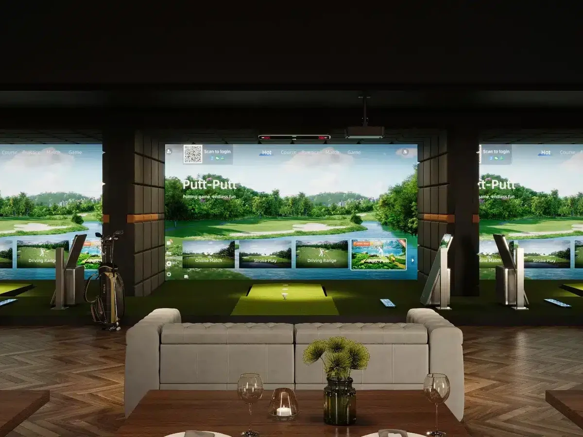 Commercial indoor golf bay environment with multiple simulator bays and lounge seating